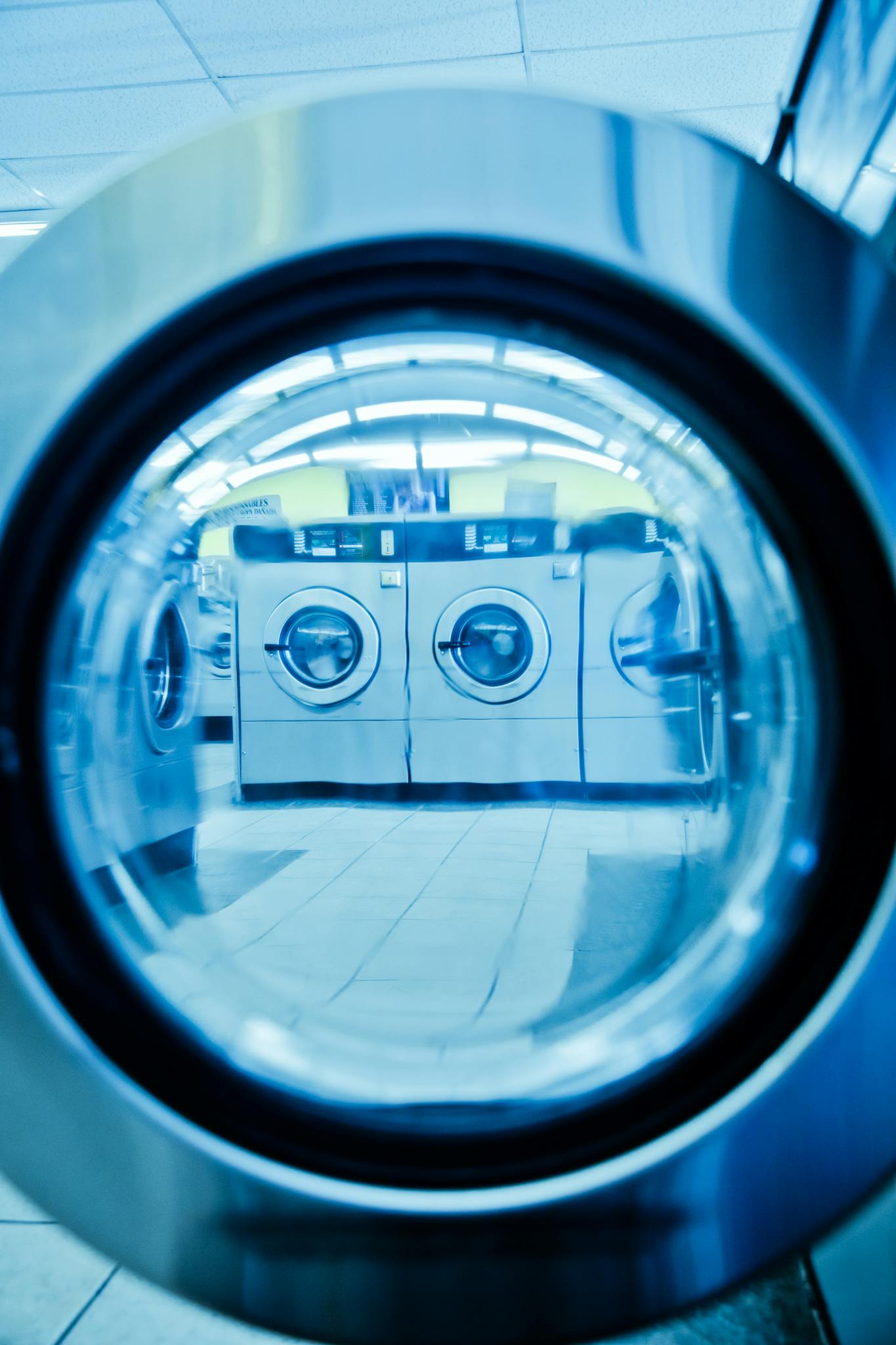 Close-up view of washers in a contemporary laundromat, highlighting clean technology.